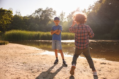 Photo of Cute little boys spending time in nature on sunny day