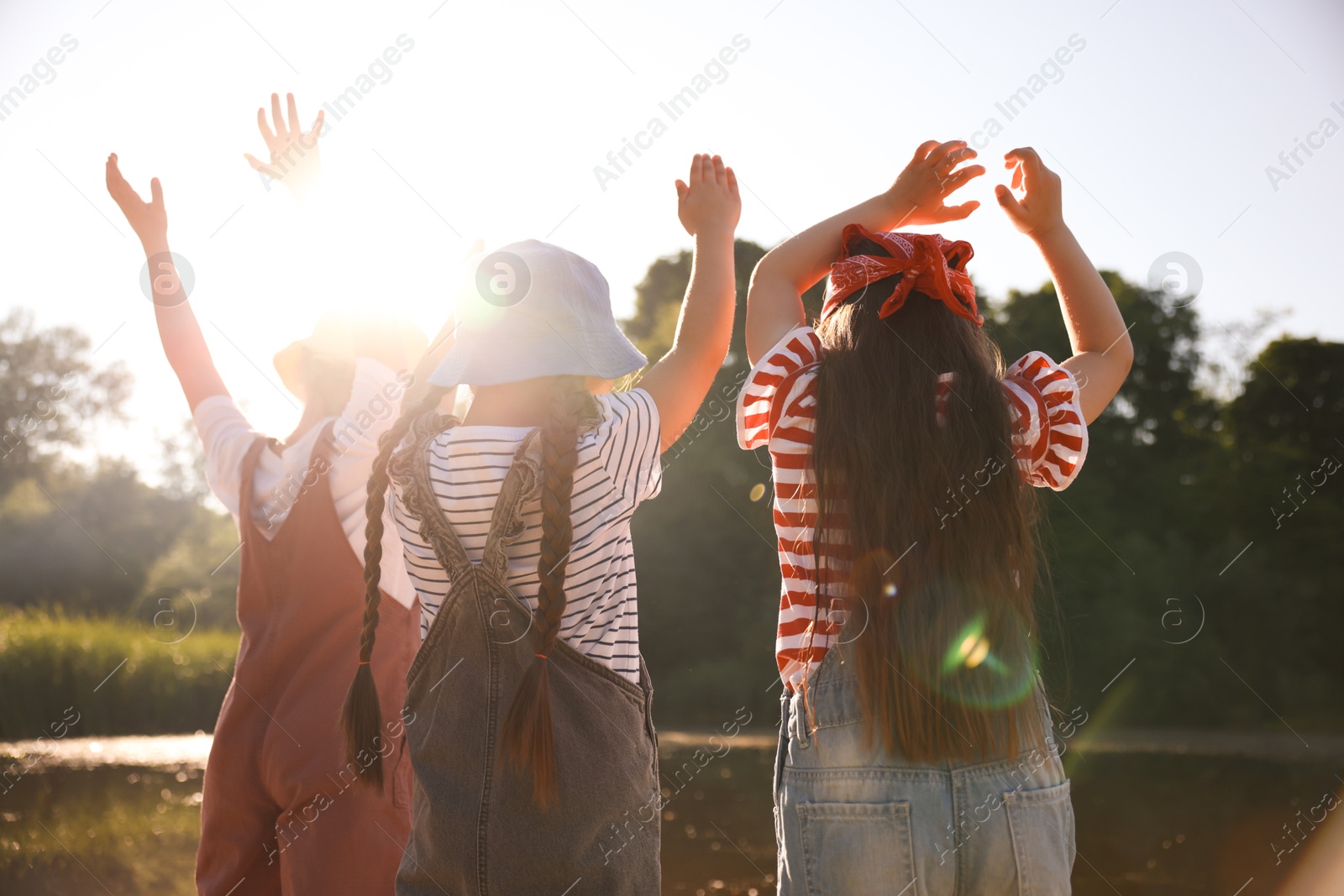 Cute little girls spending time in nature on sunny day Photo of Cute little girls spending time in nature on sunny day