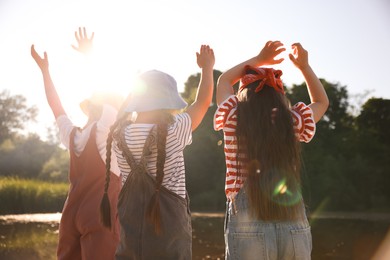 Photo of Cute little girls spending time in nature on sunny day