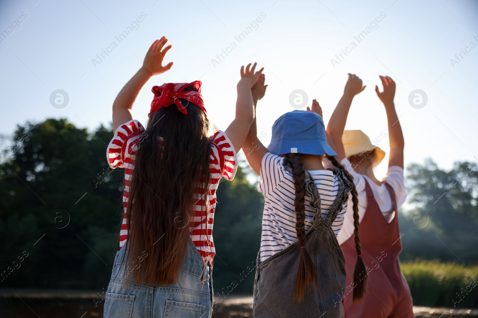 Cute little girls spending time in nature on sunny day Photo of Cute little girls spending time in nature on sunny day