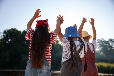Photo of Cute little girls spending time in nature on sunny day