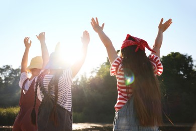 Photo of Cute little girls spending time in nature on sunny day