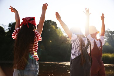 Photo of Cute little girls spending time in nature on sunny day