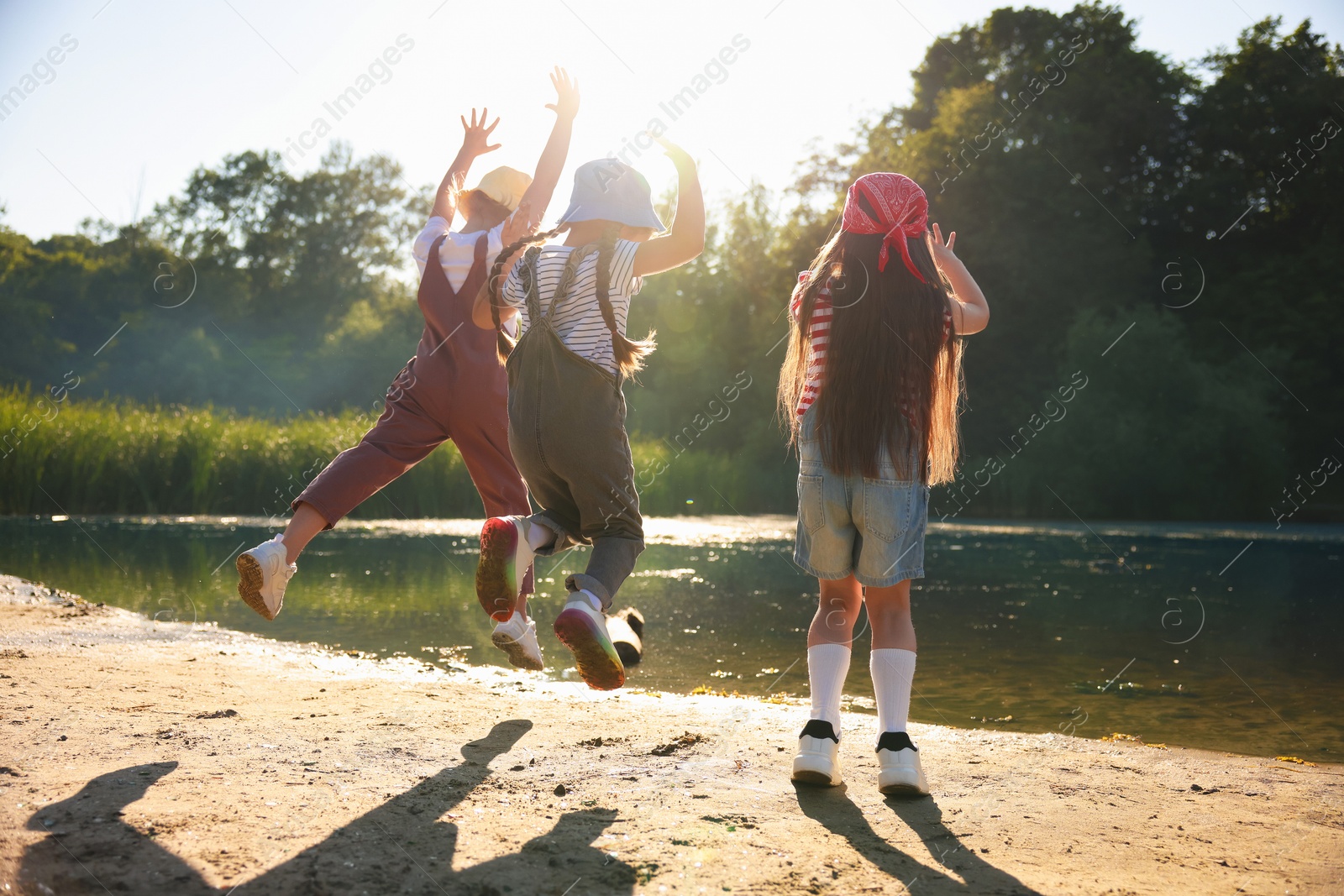 Cute little girls spending time in nature on sunny day Photo of Cute little girls spending time in nature on sunny day