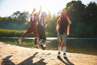 Photo of Cute little girls spending time in nature on sunny day