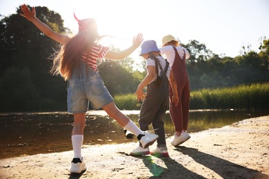 Photo of Cute little girls spending time in nature on sunny day