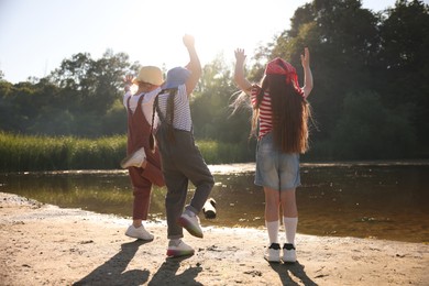 Photo of Cute little girls spending time in nature on sunny day