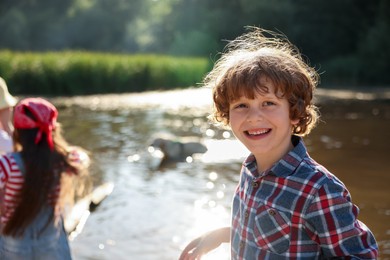 Photo of Children in nature, selective focus. Portrait of cute little boy outdoors