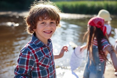 Photo of Children in nature, selective focus. Portrait of cute little boy outdoors