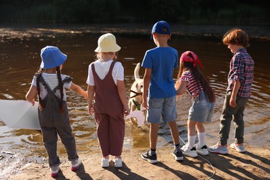 Photo of Children and dog with wooden stick in nature