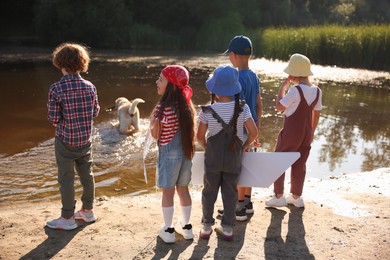 Photo of Group of children and dog in nature