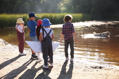 Photo of Group of children and dog in nature