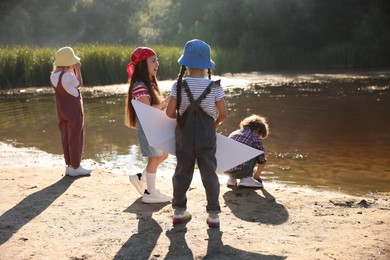 Photo of Children spending time by lake in nature