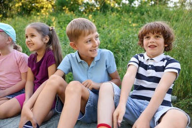 Photo of Children spending time in nature on summer day