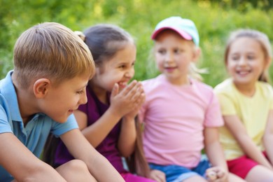 Photo of Children spending time in nature on summer day, selective focus