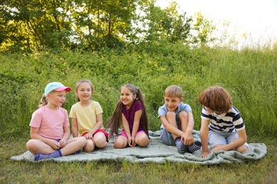 Photo of Children spending time in nature on summer day