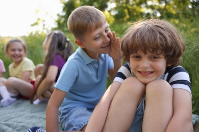 Photo of Children spending time in nature on summer day, selective focus