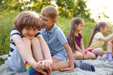 Photo of Children spending time in nature on summer day, selective focus