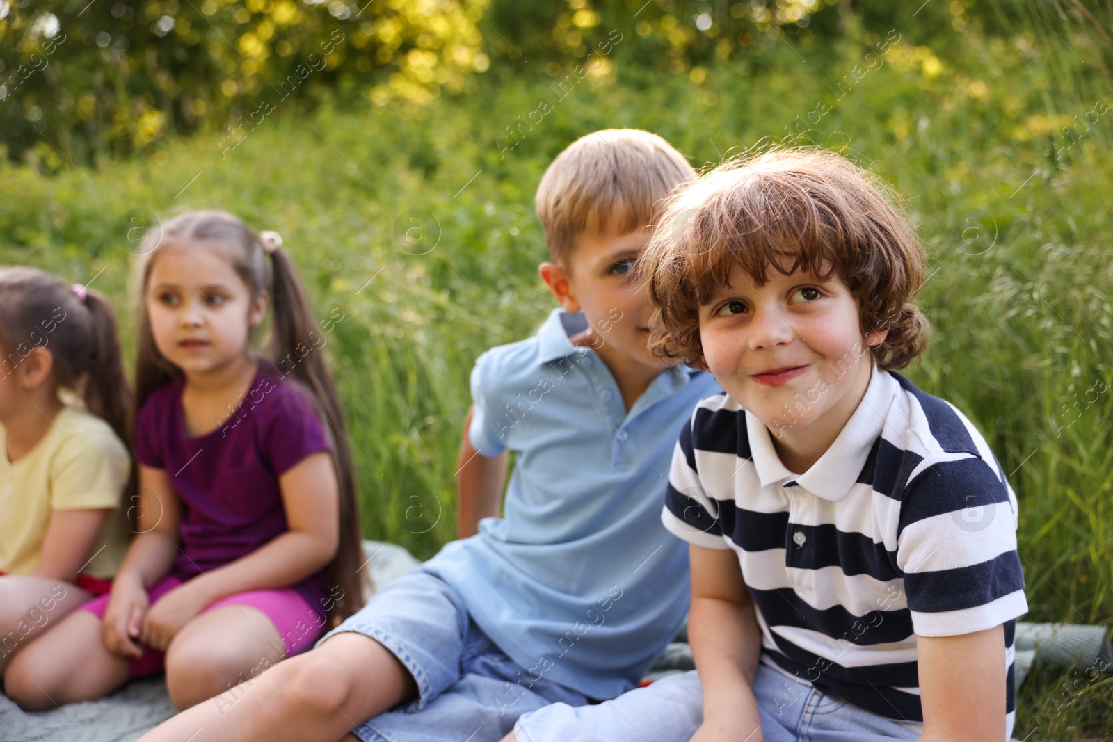 Children spending time in nature on summer day, selective focus Photo of Children spending time in nature on summer day, selective focus