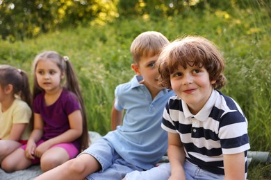 Photo of Children spending time in nature on summer day, selective focus