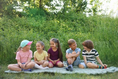 Photo of Children spending time in nature on summer day