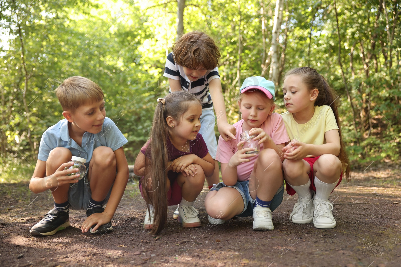 Group of children with jars in nature Photo of Group of children with jars in nature