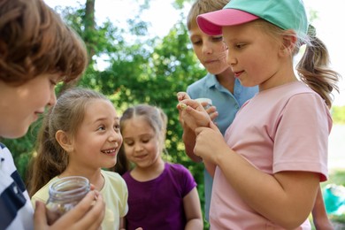 Photo of Children in nature. Cute little girl with snail outdoors, selective focus