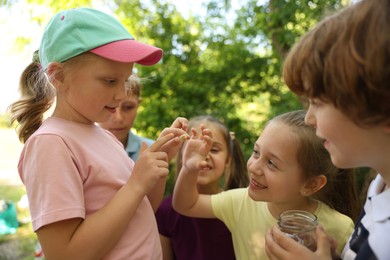 Photo of Children in nature. Cute little girl with snail outdoors, selective focus