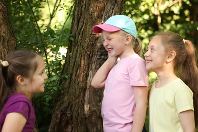 Photo of Cute little girl and her friends playing in nature