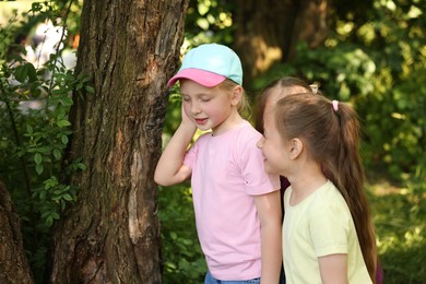 Photo of Cute little girl and her friends playing in nature