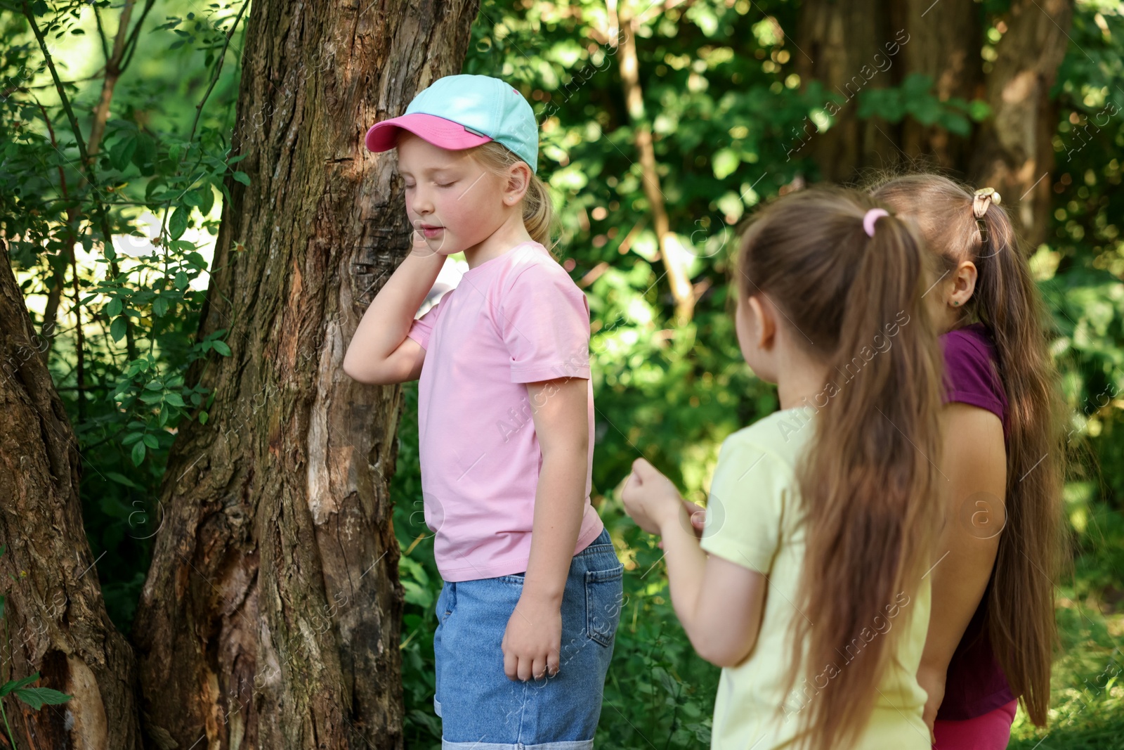 Cute little girl and her friends playing in nature Photo of Cute little girl and her friends playing in nature