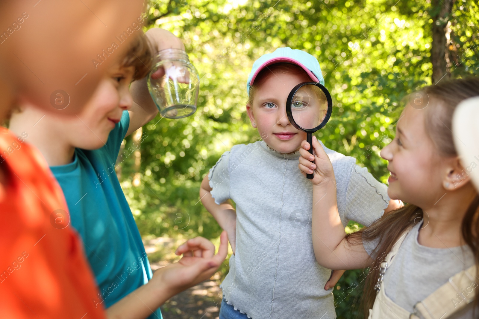 Group of children with magnifying glass in nature, selective focus Photo of Group of children with magnifying glass in nature, selective focus