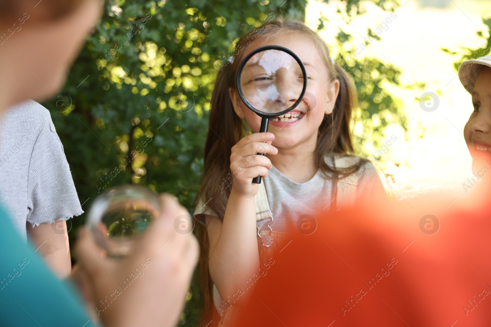 Group of children with magnifying glass in nature, selective focus Photo of Group of children with magnifying glass in nature, selective focus