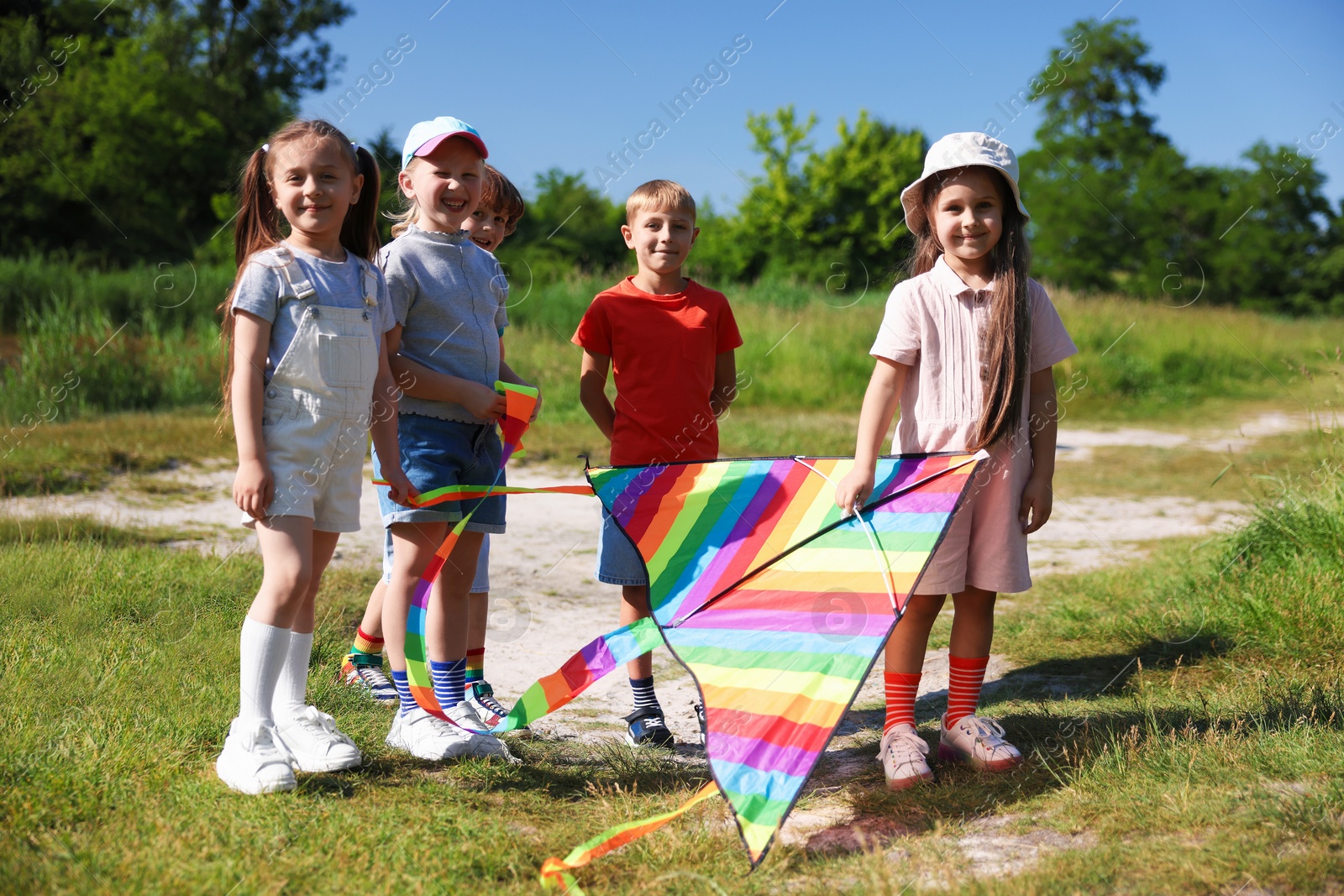 Happy children with colorful kite in nature Photo of Happy children with colorful kite in nature