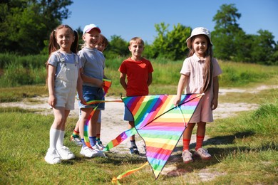 Photo of Happy children with colorful kite in nature