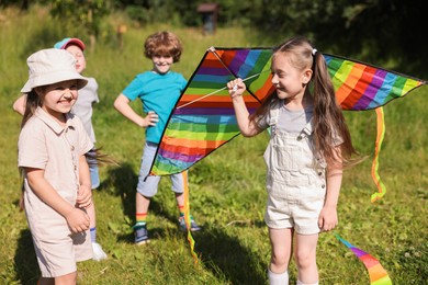Photo of Happy children with colorful kite in nature