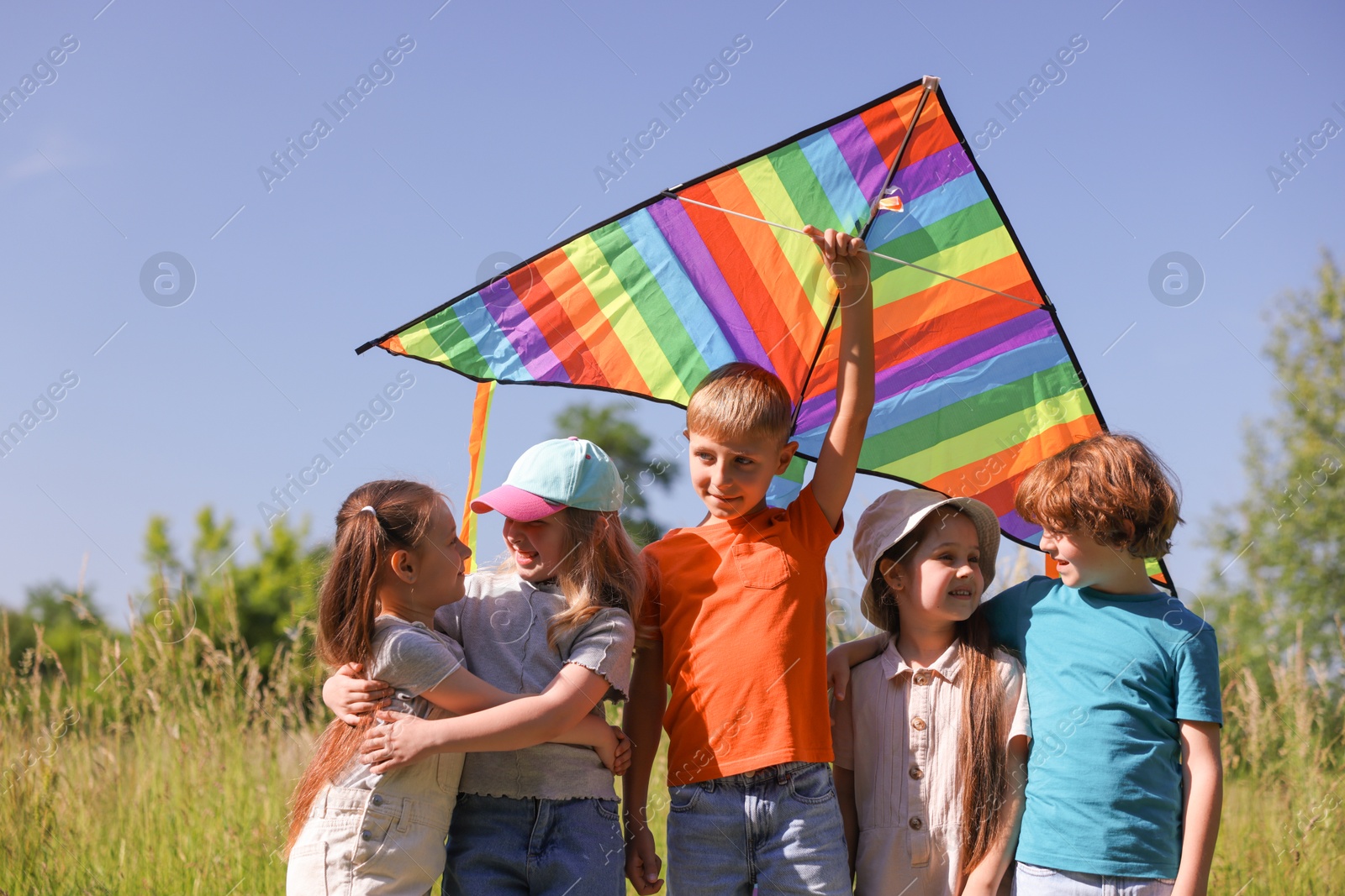 Happy children with colorful kite in nature Photo of Happy children with colorful kite in nature