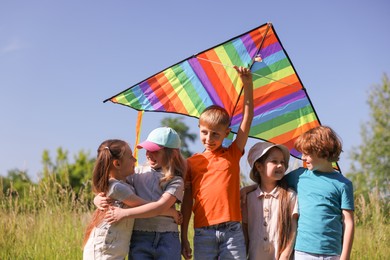 Photo of Happy children with colorful kite in nature