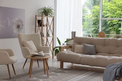 Photo of Stylish sofa and other furniture in living room. Interior design