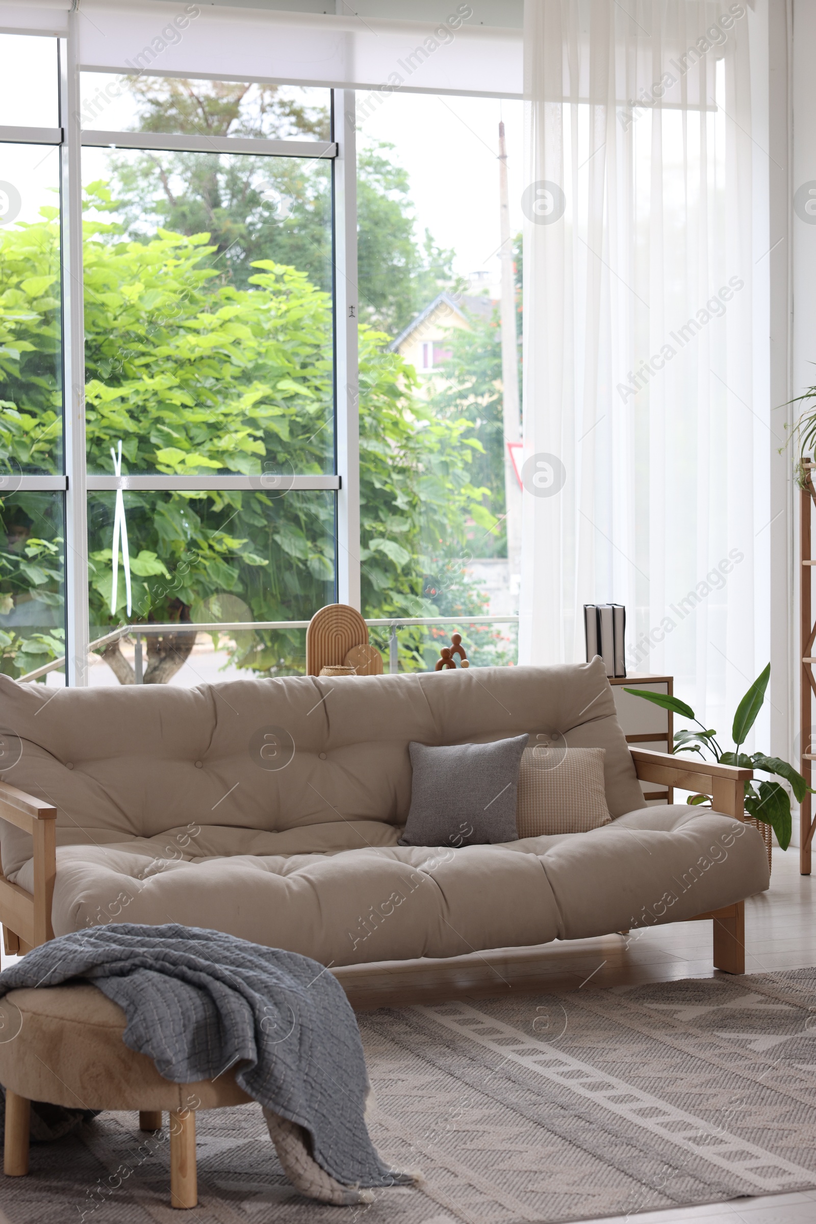 Photo of Stylish sofa and other furniture in living room. Interior design