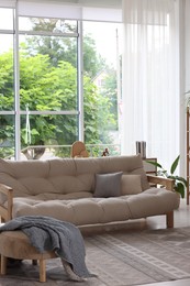 Photo of Stylish sofa and other furniture in living room. Interior design