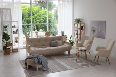 Photo of Stylish sofa and other furniture in living room. Interior design