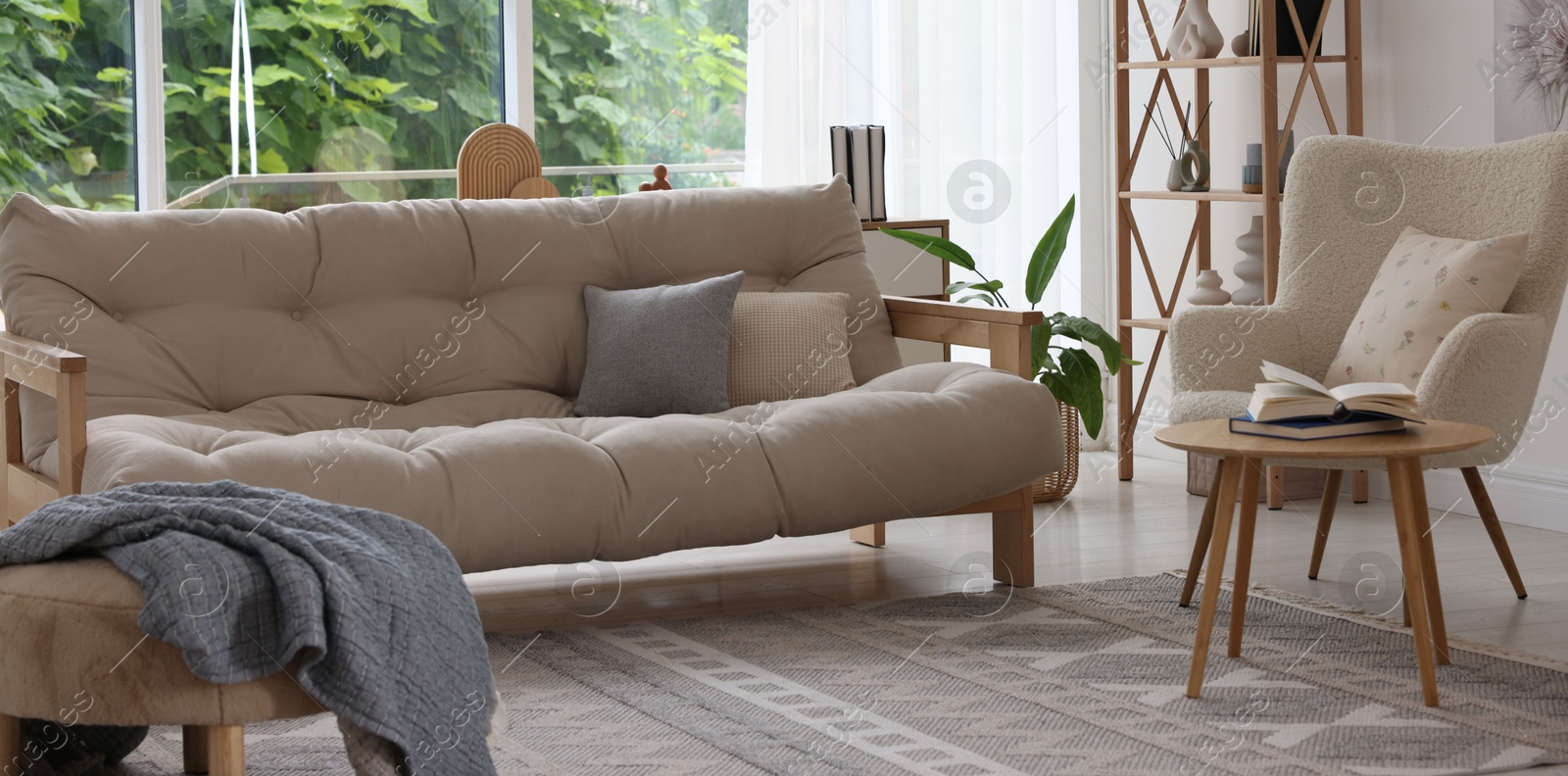 Photo of Stylish sofa and other furniture in living room. Interior design