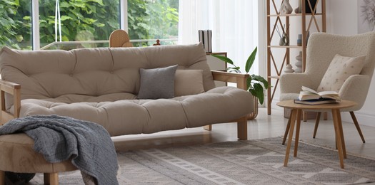 Photo of Stylish sofa and other furniture in living room. Interior design