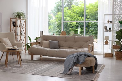 Photo of Stylish sofa and other furniture in living room. Interior design