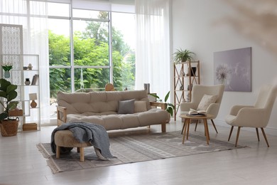 Photo of Stylish sofa and other furniture in living room. Interior design