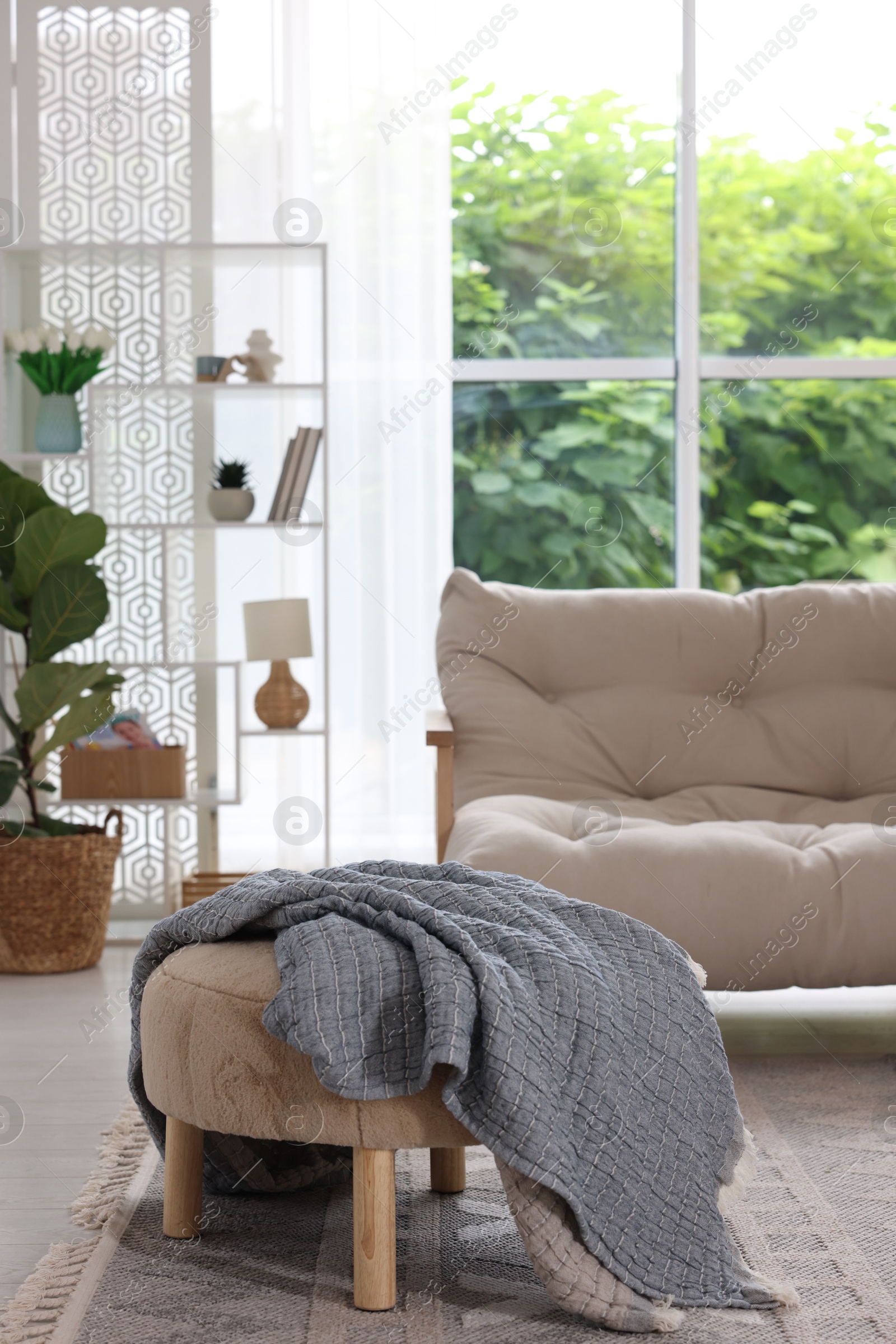 Photo of Stylish sofa and other furniture in living room. Interior design