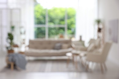 Photo of Blurred view of stylish furniture in living room. Interior design
