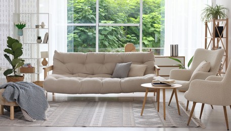 Photo of Stylish sofa and other furniture in living room. Interior design