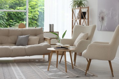 Photo of Stylish sofa and other furniture in living room. Interior design